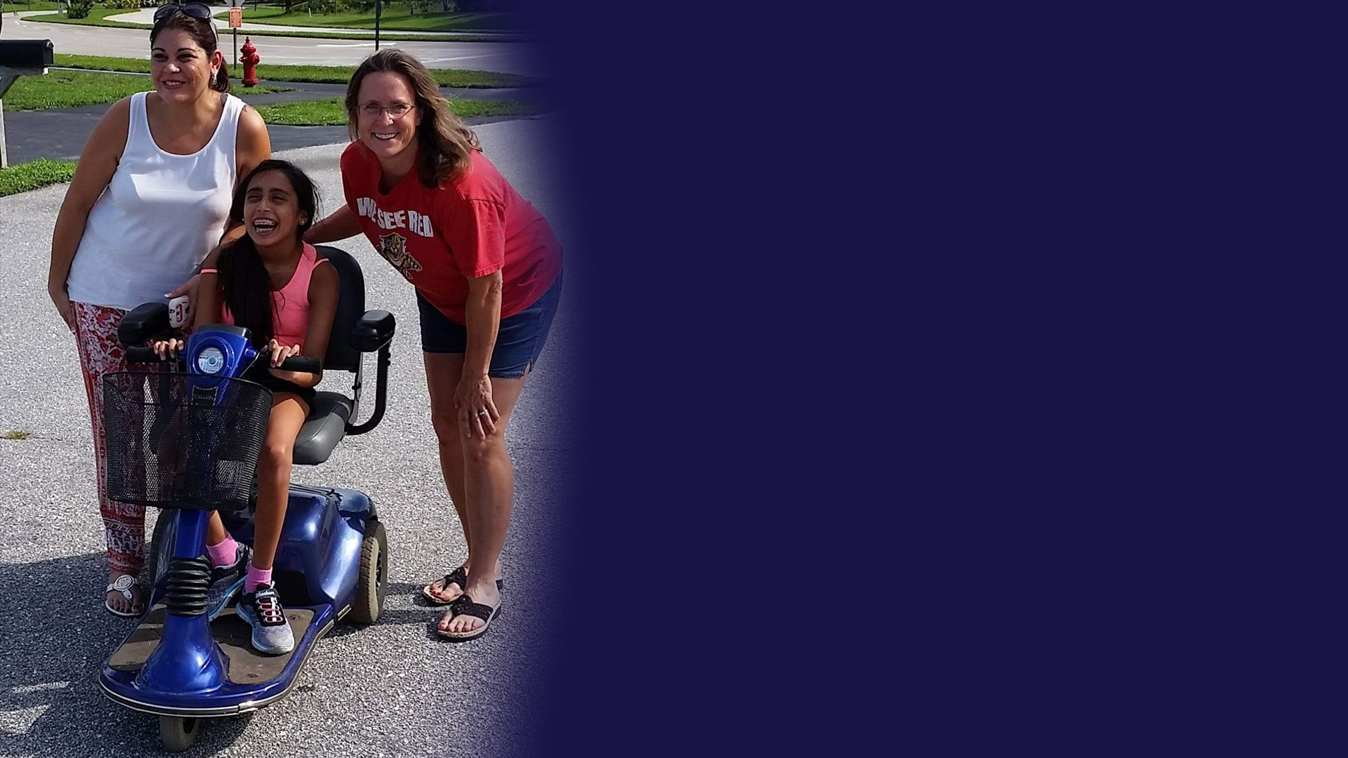 young girl in a blue scooter with two women